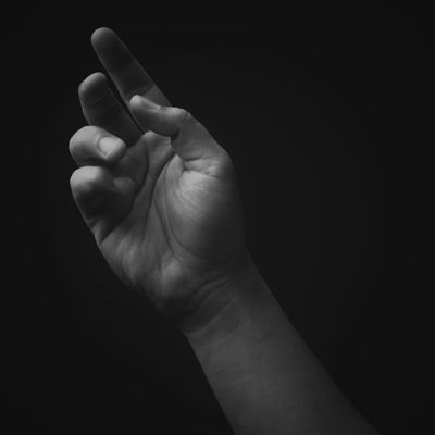 A subtle silhouette of a person meditating, blending into the dark background.